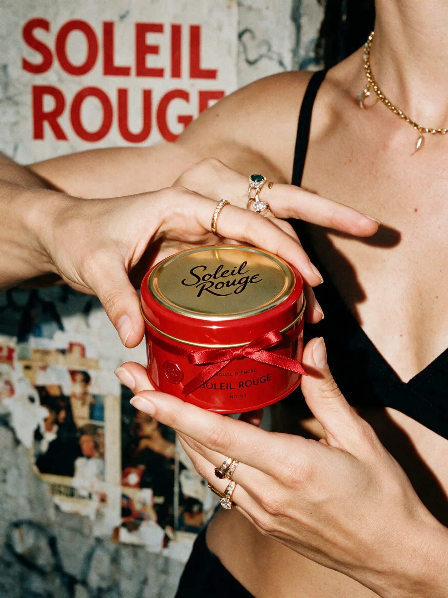 Soleil Rouge product held against a poster wall